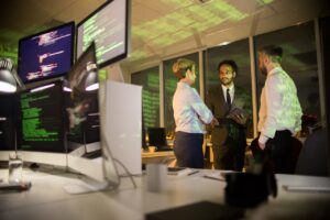 Group of professionals discussing cybersecurity strategies in an office.